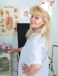 Bawdy granny in nurse uniform revealing her rack and soaking wet cunt